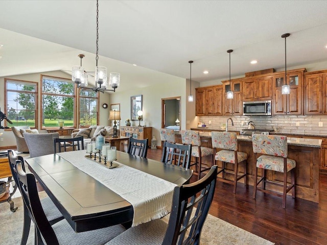 7496 Fairway Ln, Breezy Point, MN 56472 - dining space with dark wood finished floors, a chandelier, recessed lighting, and vaulted ceiling