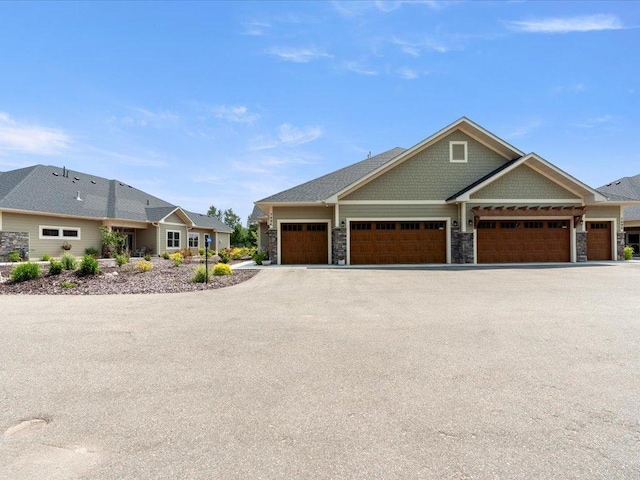 7496 Fairway Ln, Breezy Point, MN 56472 - view of front facade with stone siding, driveway, and an attached garage