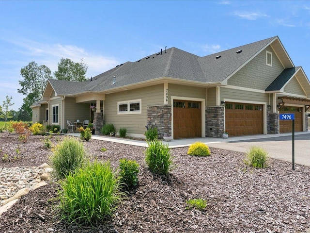 7496 Fairway Ln, Breezy Point, MN 56472 - view of front of property with an attached garage, driveway, and stone siding