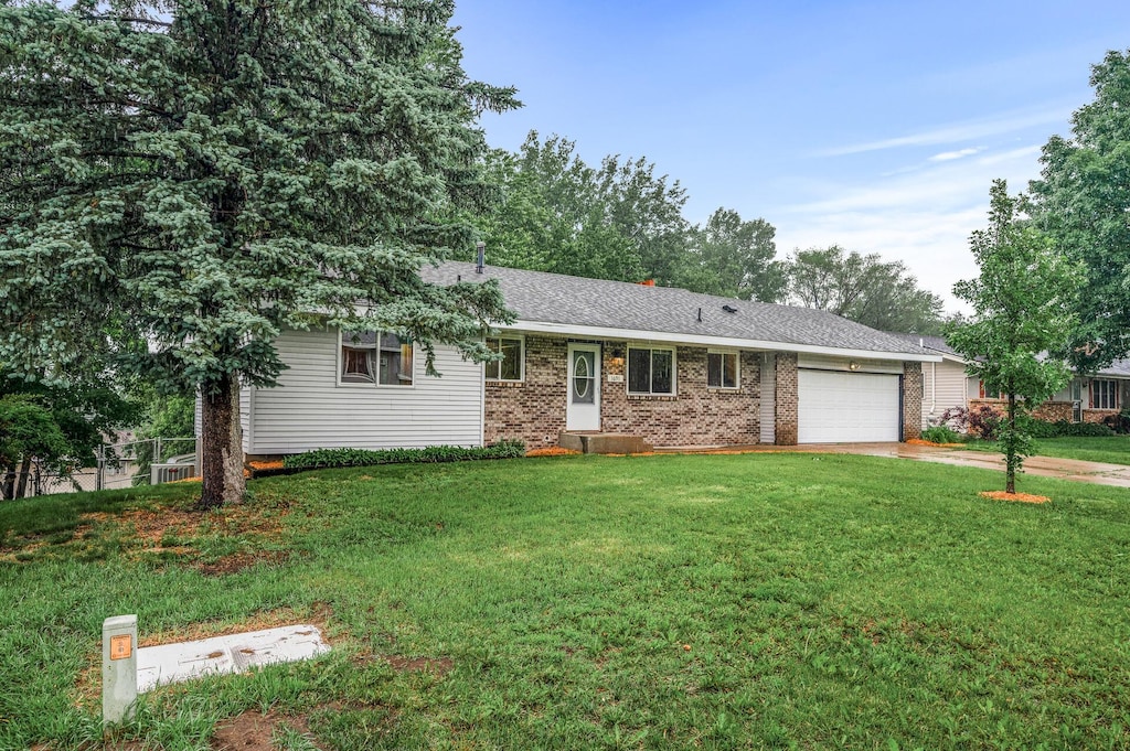 1691 Shakopee Ave E, Shakopee, MN 55379 - single story home with an attached garage, driveway, a front yard, and brick siding