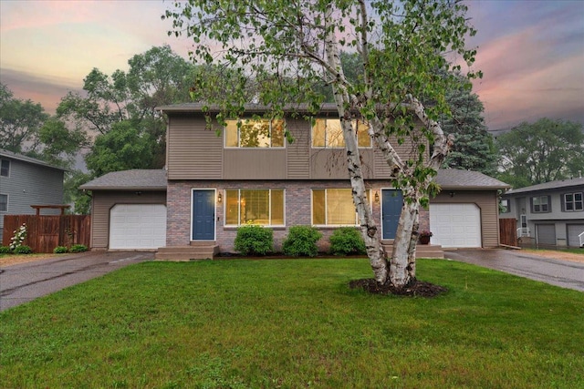 751 Sand Hill Pt, North Hudson, WI 54016 - view of front of home featuring driveway, an attached garage, and brick siding