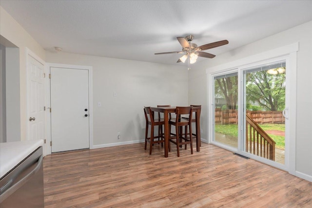 751 Sand Hill Pt, North Hudson, WI 54016 - dining space featuring wood finished floors, ceiling fan, and baseboards