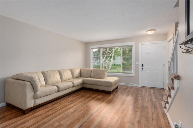 751 Sand Hill Pt, North Hudson, WI 54016 - living room with light wood-style flooring, stairs, and baseboards