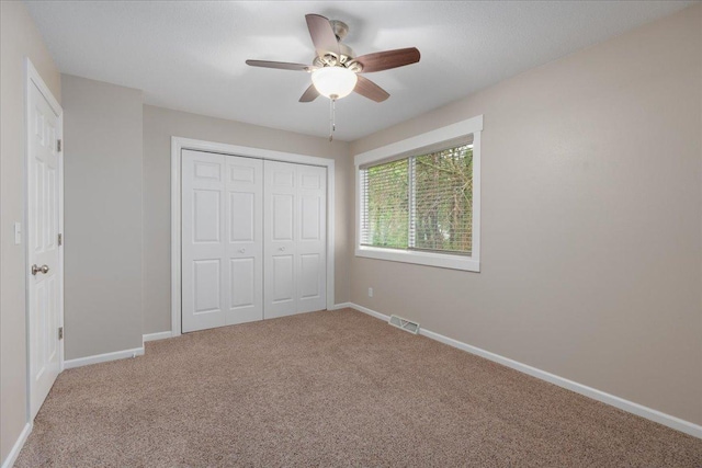751 Sand Hill Pt, North Hudson, WI 54016 - unfurnished bedroom with carpet flooring, a closet, baseboards, and a ceiling fan