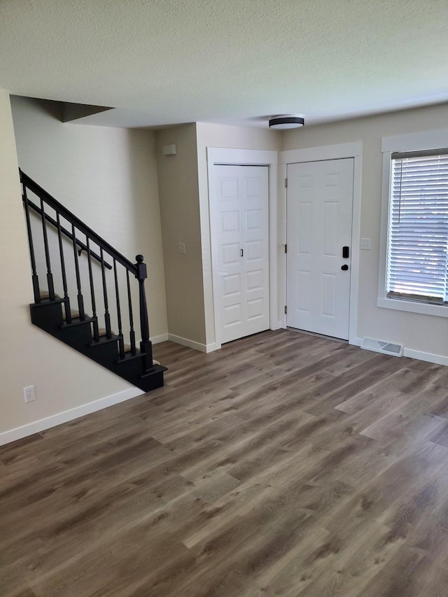 751 Sand Hill Pt, North Hudson, WI 54016 - foyer featuring wood finished floors, baseboards, a textured ceiling, and stairs
