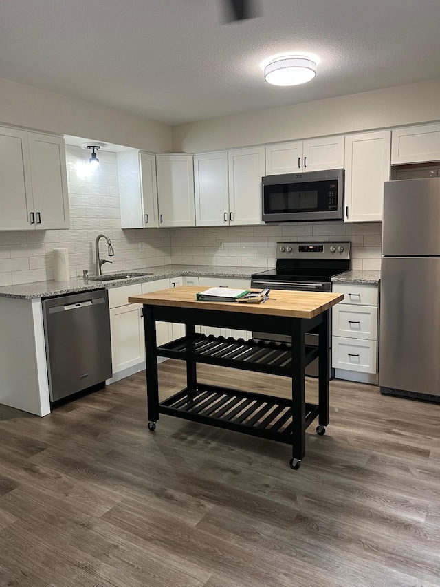 751 Sand Hill Pt, North Hudson, WI 54016 - kitchen featuring stainless steel appliances, tasteful backsplash, white cabinetry, and a sink