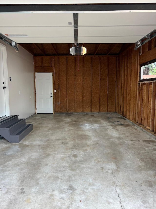 751 Sand Hill Pt, North Hudson, WI 54016 - garage with a garage door opener and wood walls