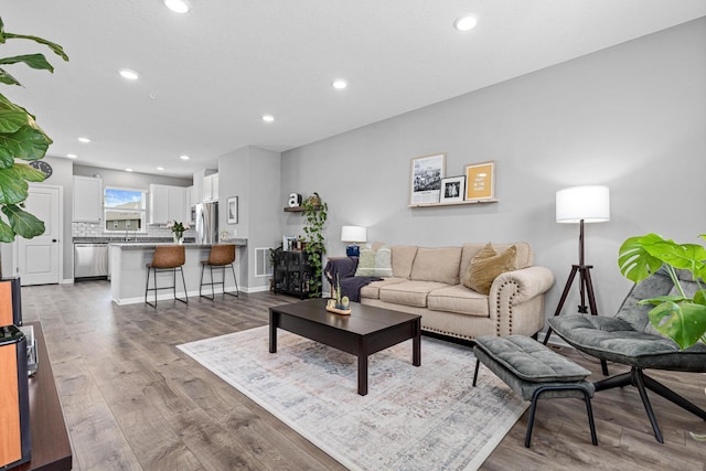 8756 Granite Ln, Woodbury, MN 55129 - living area with recessed lighting, wood finished floors, and baseboards