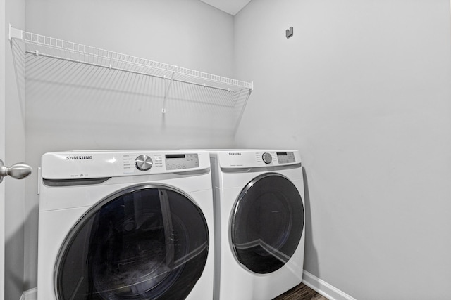 8756 Granite Ln, Woodbury, MN 55129 - laundry room featuring washing machine and dryer, wood finished floors, and baseboards