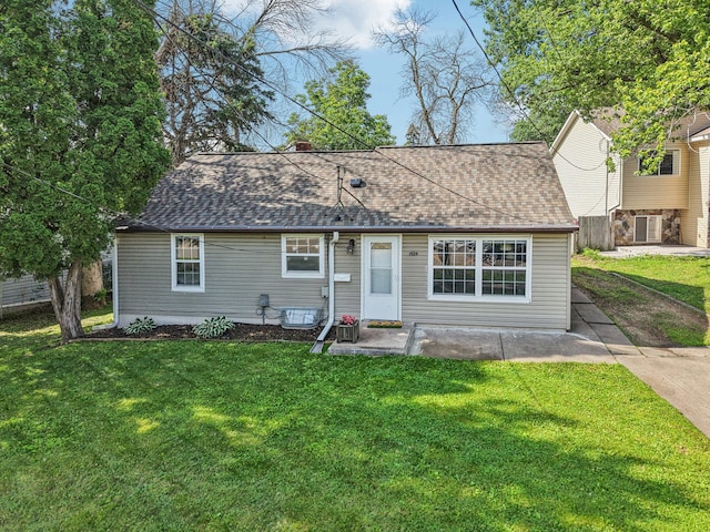1524 Arlington Ave E, Saint Paul, MN 55106 - view of front of home with a front lawn, roof with shingles, and a chimney
