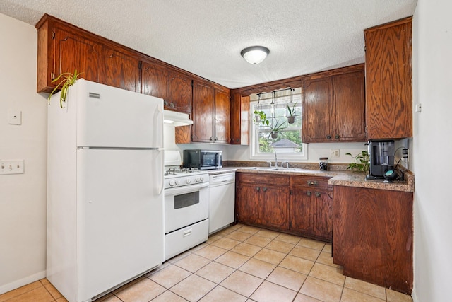 1524 Arlington Ave E, Saint Paul, MN 55106 - kitchen featuring white appliances, a textured ceiling, under cabinet range hood, and light tile patterned flooring