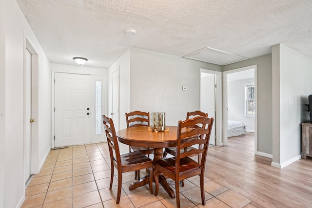 1524 Arlington Ave E, Saint Paul, MN 55106 - dining area featuring a textured ceiling and light wood-style floors