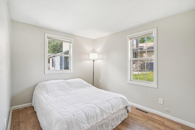 1524 Arlington Ave E, Saint Paul, MN 55106 - bedroom featuring wood finished floors and multiple windows