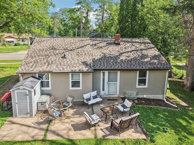 1524 Arlington Ave E, Saint Paul, MN 55106 - back of property with a shingled roof, a chimney, a patio, an outdoor living space with a fire pit, and a lawn