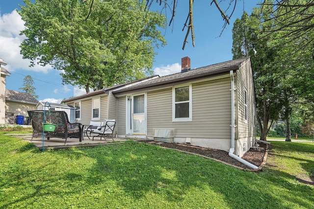 1524 Arlington Ave E, Saint Paul, MN 55106 - back of house with a patio, a chimney, and a lawn