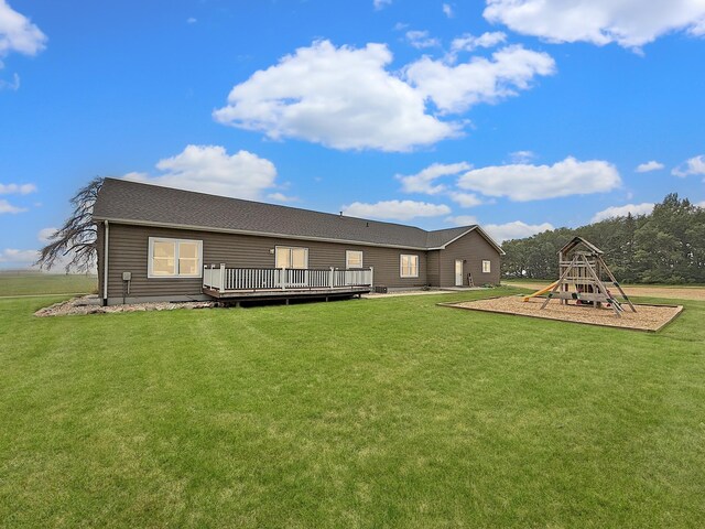 2771 271st Ave, Madison, MN 56256 - rear view of property with a playground, a wooden deck, and a lawn