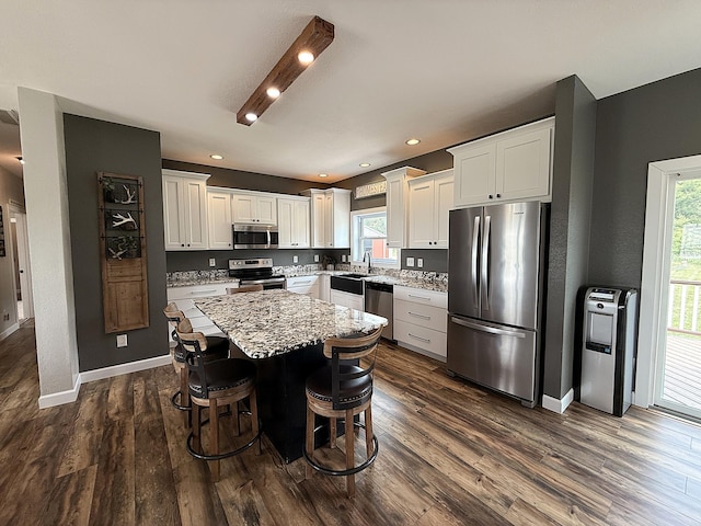 2771 271st Ave, Madison, MN 56256 - kitchen with appliances with stainless steel finishes, a kitchen island, white cabinets, healthy amount of natural light, and recessed lighting