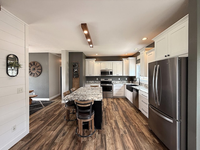 2771 271st Ave, Madison, MN 56256 - kitchen featuring stainless steel appliances, light stone countertops, dark wood finished floors, white cabinetry, and recessed lighting