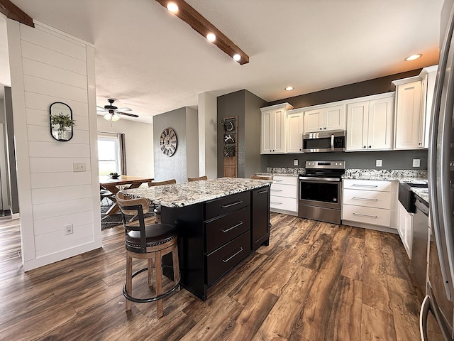 2771 271st Ave, Madison, MN 56256 - kitchen with stainless steel appliances, a kitchen island, white cabinetry, dark wood-type flooring, and recessed lighting