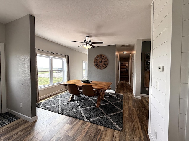 2771 271st Ave, Madison, MN 56256 - dining area with dark wood finished floors, baseboards, ceiling fan, and a textured ceiling