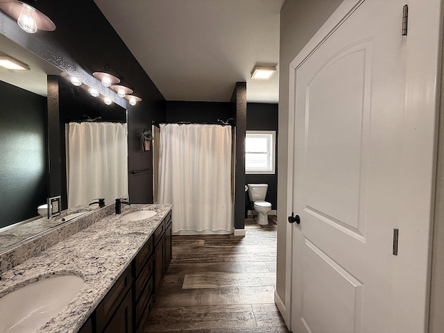 2771 271st Ave, Madison, MN 56256 - full bathroom featuring toilet, hardwood / wood-style floors, double vanity, and a shower with shower curtain