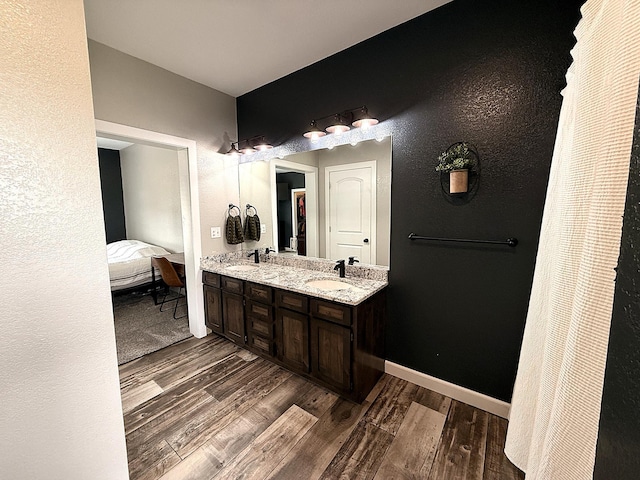 2771 271st Ave, Madison, MN 56256 - ensuite bathroom with wood finished floors, double vanity, and a textured wall
