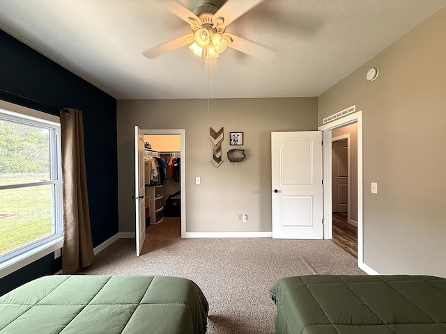 2771 271st Ave, Madison, MN 56256 - carpeted bedroom with a spacious closet, baseboards, ceiling fan, and a closet