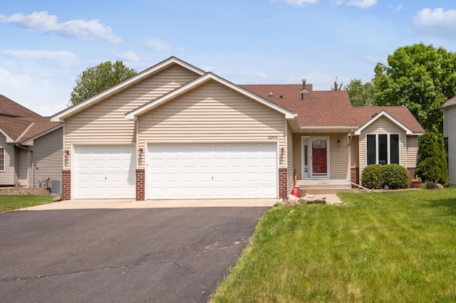 10344 Fox Run Rd, Woodbury, MN 55129 - ranch-style house featuring driveway, brick siding, a garage, and central air condition unit