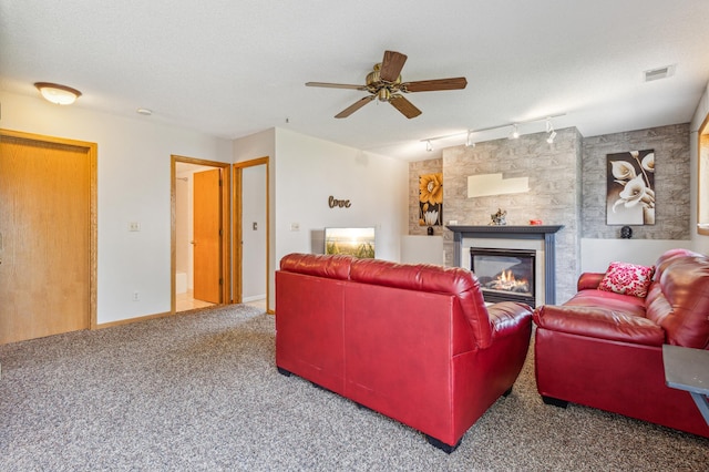 10344 Fox Run Rd, Woodbury, MN 55129 - living room featuring rail lighting, ceiling fan, a glass covered fireplace, carpet flooring, and baseboards