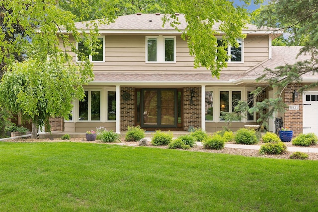 5921 Creek Pt, Minnetonka, MN 55345 - view of front of home featuring brick siding, french doors, a front lawn, a shingled roof, and a garage