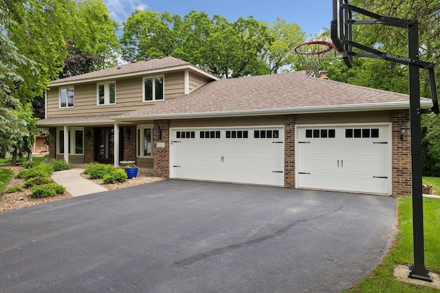 5921 Creek Pt, Minnetonka, MN 55345 - view of front of property featuring brick siding, asphalt driveway, an attached garage, a shingled roof, and a chimney