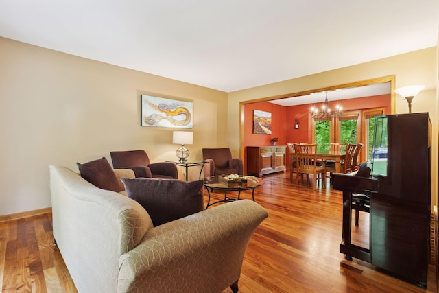 5921 Creek Pt, Minnetonka, MN 55345 - living room with wood finished floors, a chandelier, and baseboards