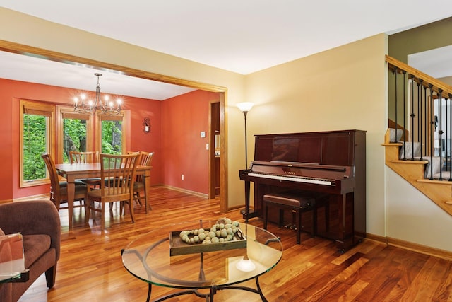 5921 Creek Pt, Minnetonka, MN 55345 - living area with stairway, wood finished floors, a chandelier, and baseboards
