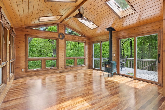 5921 Creek Pt, Minnetonka, MN 55345 - unfurnished sunroom with a skylight, a wood stove, and vaulted ceiling