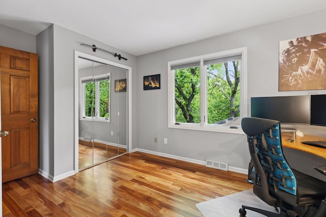 5921 Creek Pt, Minnetonka, MN 55345 - office area with healthy amount of natural light, wood finished floors, and baseboards
