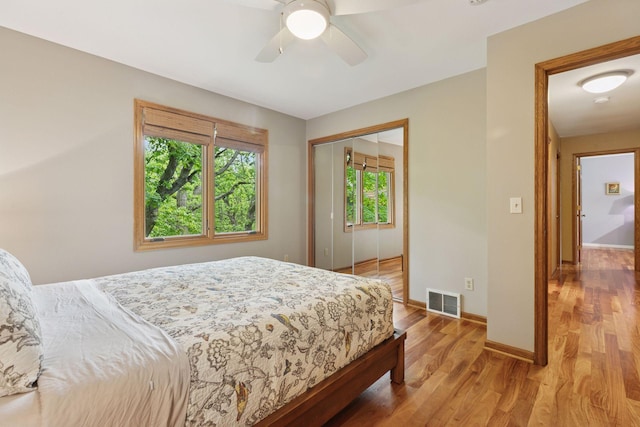 5921 Creek Pt, Minnetonka, MN 55345 - bedroom with wood finished floors, baseboards, a closet, and ceiling fan