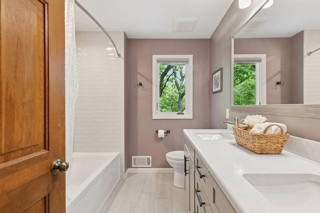 5921 Creek Pt, Minnetonka, MN 55345 - bathroom with double vanity, shower / washtub combination, toilet, and baseboards
