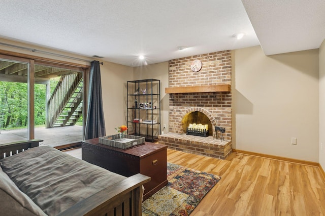 5921 Creek Pt, Minnetonka, MN 55345 - living area with wood finished floors, a fireplace, baseboards, and a textured ceiling