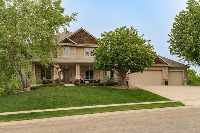 2292 Teakwood Ln SW, Rochester, MN 55902 - craftsman-style home featuring driveway, an attached garage, brick siding, a front yard, and covered porch