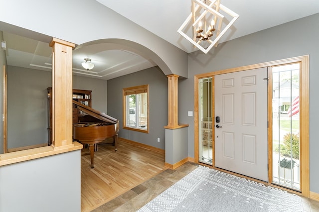 2292 Teakwood Ln SW, Rochester, MN 55902 - entrance foyer featuring ornate columns, arched walkways, plenty of natural light, and baseboards
