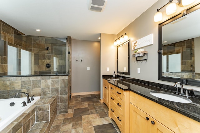 2292 Teakwood Ln SW, Rochester, MN 55902 - full bathroom with double vanity, tiled shower, a garden tub, stone finish flooring, and baseboards