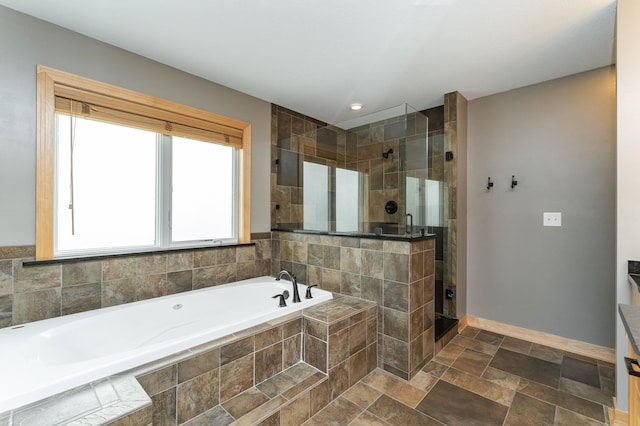 2292 Teakwood Ln SW, Rochester, MN 55902 - full bath featuring a garden tub, a shower stall, baseboards, and stone finish flooring
