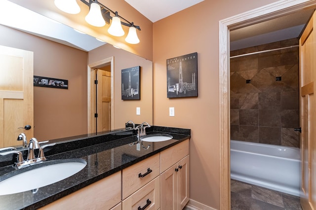 2292 Teakwood Ln SW, Rochester, MN 55902 - bathroom with double vanity, baseboards, tub / shower combination, and stone finish flooring