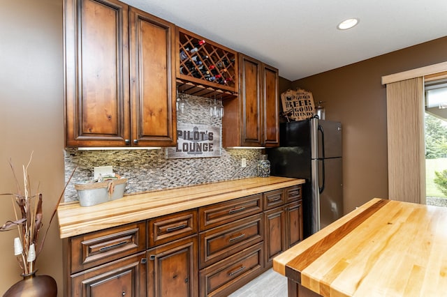 2292 Teakwood Ln SW, Rochester, MN 55902 - kitchen with butcher block countertops, freestanding refrigerator, decorative backsplash, and recessed lighting