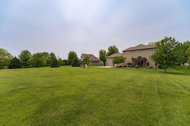 2292 Teakwood Ln SW, Rochester, MN 55902 - view of green lawn with stairs and a wooden deck