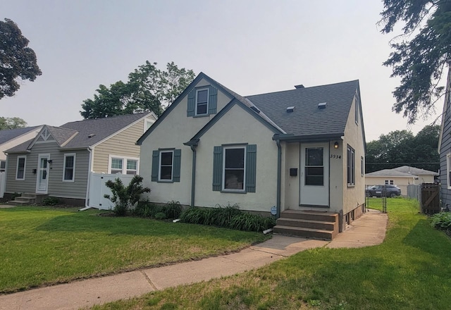 3934 Scott Ave N, Robbinsdale, MN 55422 - view of front of home featuring entry steps, stucco siding, and a shingled roof
