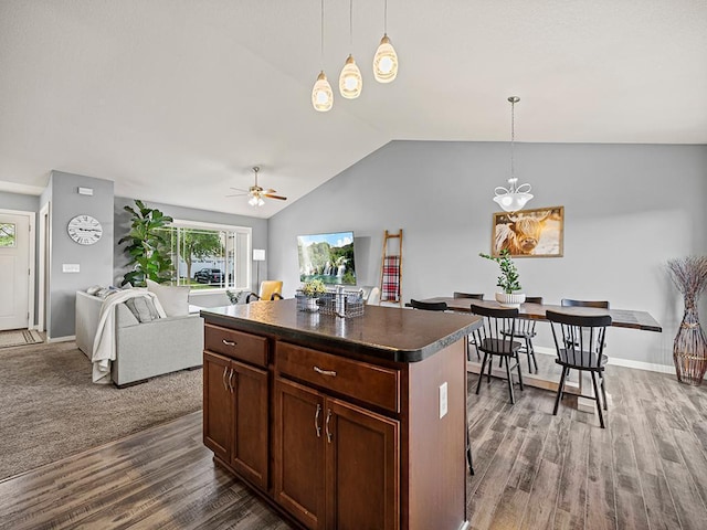 1308 Timber Ln, Buffalo, MN 55313 - kitchen with dark countertops, wood finished floors, plenty of natural light, lofted ceiling, and a center island