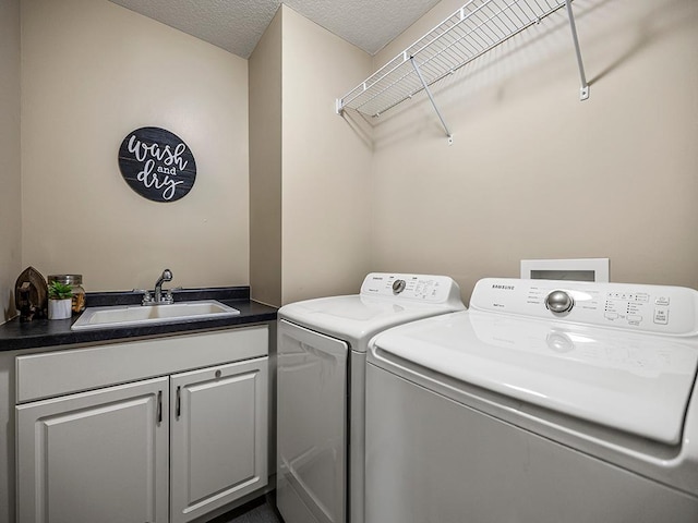 1308 Timber Ln, Buffalo, MN 55313 - washroom featuring separate washer and dryer, cabinet space, and a textured ceiling