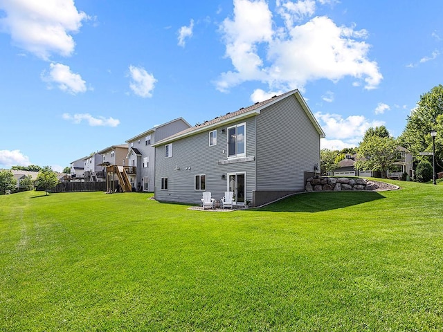 1308 Timber Ln, Buffalo, MN 55313 - rear view of property with a lawn, a playground, and a residential view