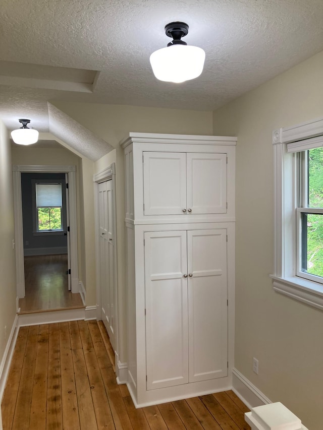 112 Harriet St S, Stillwater, MN 55082 - hall with a textured ceiling, wood-type flooring, and baseboards